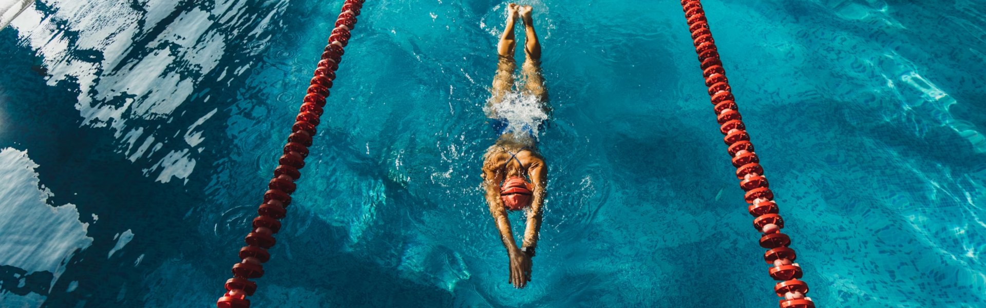 Swimmer doing backstroke in a heated lap pool